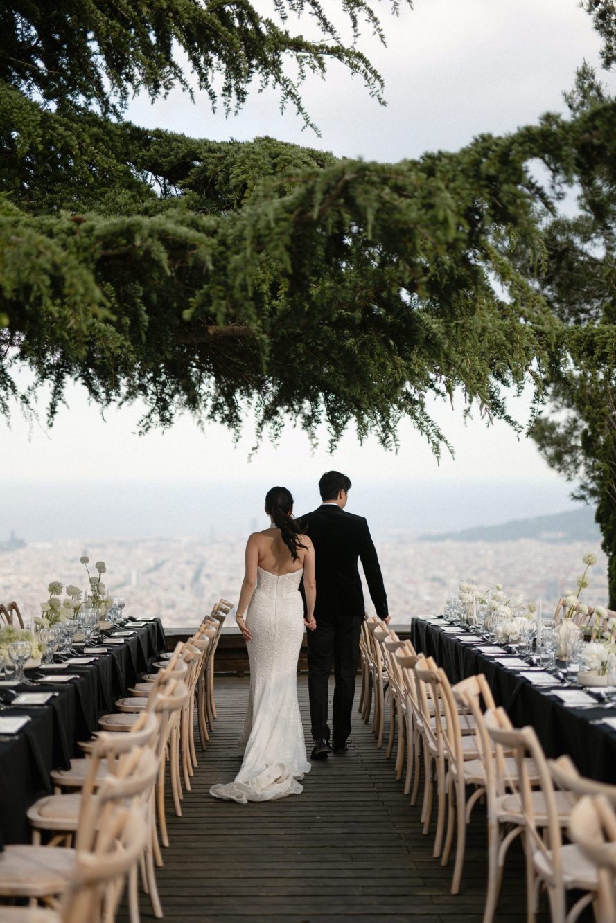Couple walking towards scenic outdoor venue.